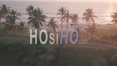 A Single Vehicle On The Road Beside The Coastline Of Varkala Beach In The State Of Kerala, India - Aerial Drone Shot