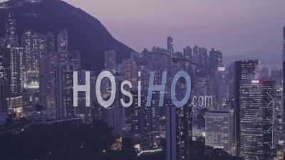 Hong Kong Downtown Skyscrapers And Buildings Cityscape At Night. Aerial Drone View