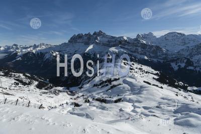 Snowcapped Mountains And Ski Slopes With Blue Sky At The Ski Resort Of Morzine In The Alps Mountain Range Of France, Europe