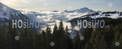 Dramatic Alps Mountains Landscape With Low Misty Clouds And Pine Tree Forests At The Ski Resort Of Morzine, France, Europe