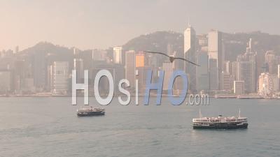Le Charmant Bateau Star Ferry De Croisière Sur L'eau Calme Dans Le Port De Victoria à Hong Kong Avec Des Immeubles De Grande Hauteur En Arrière-Plan Sur Un Jour Brumeux - Plan Large