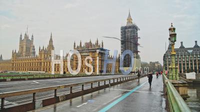 London In Coronavirus Covid-19 Lockdown With Empty Roads And Streets With No Cars Or Traffic At Westminster Bridge With Houses Of Parliament, Big Ben And People Walking In England, Uk At Rush Hour