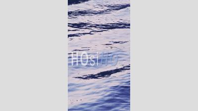 Vertical Background Video Of Flowing Water, A Nature Abstract With Ripples During A Cool Blue Winter Day