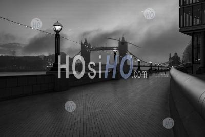 Black And White Tower Bridge In London With Dramatic Clouds And Sky, Showing Iconic Famous City Skyline On Day One Of Coronavirus Covid-19 Lockdown In England, Uk