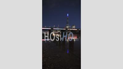 Vertical Video Of London Skyline With Lights At Night On The River Thames Beach At Low Tide Looking At The Shard, Shot In Coronavirus Covid-19 Lockdown
