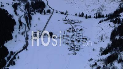 Aerial Footage Of Poeple Sleding Around A Mountain Village Under Snow In The Vanoise National Park, Seen From Drone, Champagny-Le-Haut, Savoie, France