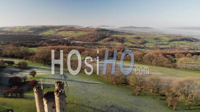 Aerial Drone Video Of Broadway Tower, A Famous Iconic Tourist Attraction In The Cotswolds Hills, Iconic English Landmark With Beautiful British Countryside Scenery In Mist, Gloucestershire, England, United Kingdom