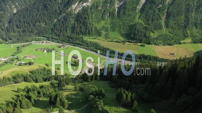Medels Im Rheinwald, Green Forest, Winding Road In Swiss Alps Winding Road - Video Drone Footage
