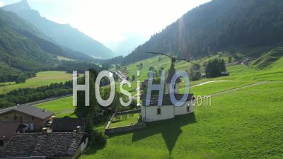 Medels Im Rheinwald, Green Meadows And A Small Church In The Swiss Alps - Video Drone Footage