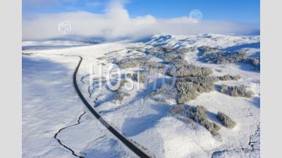  Aerial View Of A82 Road Passing Over Snow Covered Rannoch Moor In Winter, Scotland, Uk - Aerial Photography