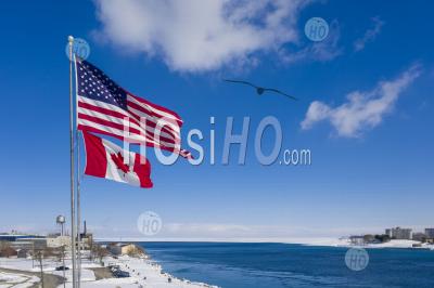 Us And Canadian Flags At Border Crossing - Aerial Photography