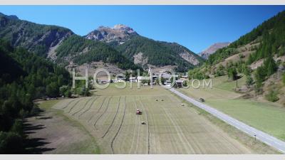 Work In The Fields In Arvieux In The Queyras, At The Foot Of The Col D'izoard, Hautes-Alpes, France, Viewed From Drone