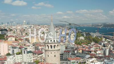Close Up Of Galata Tower Top Revealing Istanbul Skyscraper Skyline Of Beautiful Blue Sky Summer Day, Aerial View Forward - Video Drone Footage