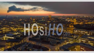 Stunning Munich Cityscape At Night With Glowing City Streets And Office Building, Magical Day To Night Aerial Hyper Lapse Moving Time Lapse Above Big Metropolitan Area - Video Drone Footage