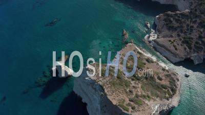 Aerial Wide Establishing Shot Of Tropical Bay In Greece With White Rocks And Boats In The Ocean 4k - Video Drone Footage