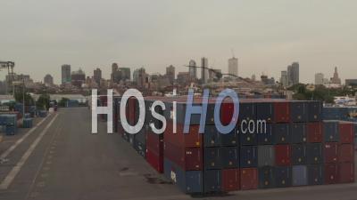 Close Up Aerial Dolly Shot Of Red And Blue Containers Stacked On Top Of Each Other With New York City Skyline In The Background 4k - Video Drone Footage