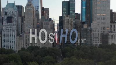 View Of 7th Avenue Traffic And Times Square Over New York City Central Park At Sunset With City Lights In 4k - Video Drone Footage