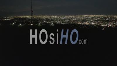 Spectacular Flight Over Mount Lee And Hollywood Sign At Night With Los Angeles Cityscape Lights 4k - Video Drone Footage