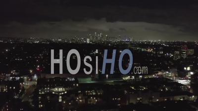Over Dark Hollywood Los Angeles At Night With Clouds Over Downtown And City Lights 4k - Video Drone Footage