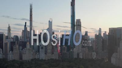 View Of 7th Avenue Traffic And Times Square Over New York City Central Park At Sunset With City Lights In 4k - Video Drone Footage