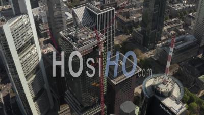 Aerial View Close Up View Of Skyscraper Construction Site In Urban Environment With City Car Traffic And Reflections In Tower At Sunny Day In Frankfurt Am Main Germany 4k - Video Drone Footage