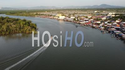 Fishing Boat Move Near Fishing Village - Video Drone Footage