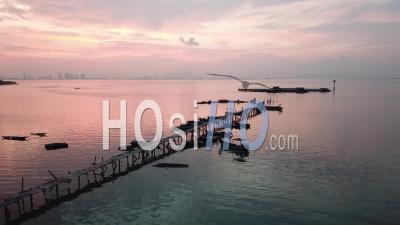 Aerial View Silhouette Fishing Boat Leave Jetty In Colorful Morning - Video Drone Footage