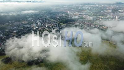 Aerial View Bukit Mertajam Town And Yellow Rice Paddy Field Through The Cloud - Video Drone Footage