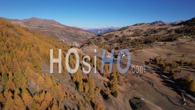 Napoleon Lake And Larch Forest In Autumn Near The Resort Of Vars, Hautes-Alpes, France, Viewed From Drone