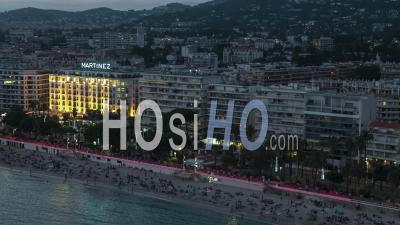 Establishing Aerial View Shot Of Beautiful Cannes French Riviera Fr, French Riviera, Alpes-Maritimes, France At Night Evening - Video Drone Footage