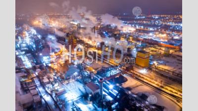 Aerial View Of Steel Plant At Night With Smokestacks And Fire Blazing Out Of The Pipe. Industrial Panoramic Landmark With Blast Furnance Of Metallurgical Production. Concept Of Environmental Pollution