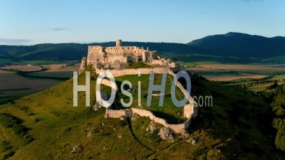 Flying Over Unesco Spis Castle Ruins, Lit By Evening Sun - Video Drone Footage