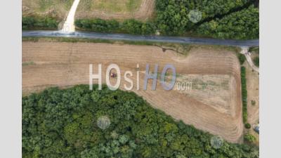 Tractor Plowing A Field In Summer In Saint-Georges-Blancaneix In Dordogne - Aerial Photography