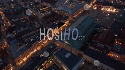 Scenic Aerial View Passing Through Munich, Germany Neighborhood Street At Night With Beautiful City Lights Glowing And Cars Passing By, Aerial Tilt Down High Angle - Photo Drone 