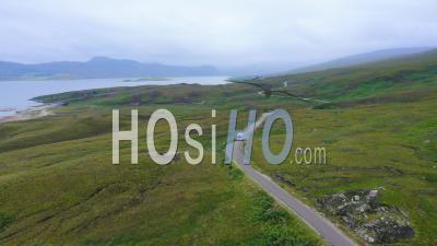 Aerial Drone View Of Scotland Highlands Road Trip Driving Holiday In Mountains, With Car On Scottish Roads Of Nc500 (north Coast 500 Route) On An Adventure In Beautiful Scottish Landscape