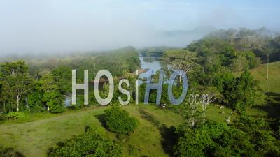 Aerial Drone View Of San Carlos River (rio San Carlos) In Costa Rica, That Connects To Nicaragua, With Lush Green Misty Rainforest Scenery And Misty Mountains, Central America