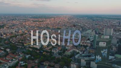Aerial Panoramic View Of Metropolis At Dusk. Houses In Residential Boroughs And Milano Centrale Railway Station. Milano, Italy. - Video Drone Footage