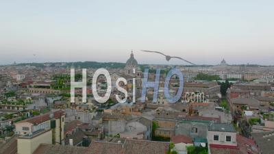 Fly Above Buildings In City Centre At Twilight. Various Old Residential Houses In Urban Thorough. Church Towers Protruding Above Other Rooftops. Rome, Italy - Video Drone Footage