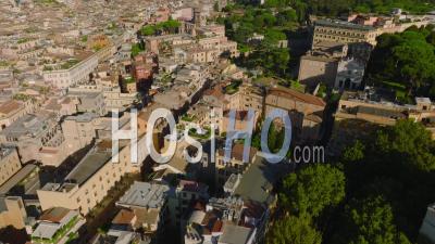 Forwards Fly Above Town Development In Old City Centre. High Angle View Of Historic Buildings Surrounded By Trees. Rome, Italy - Video Drone Footage