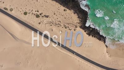 Spain, Canary Islands, Fuerteventura, Road Crossing Corralejo Dunes Natural Park - Video Drone Footage