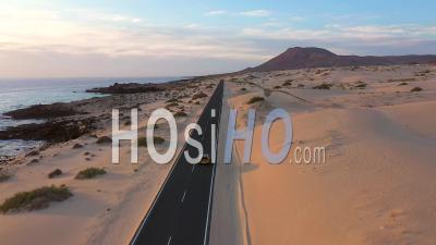 Spain, Canary Islands, Fuerteventura, Road Crossing Corralejo Dunes Natural Park - Video Drone Footage