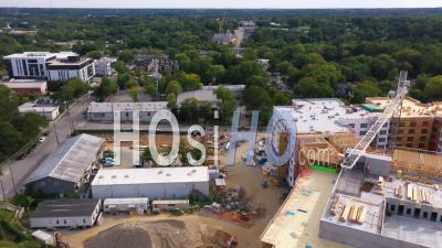 2022 - Good Aerial Over A Large Construction Site With Crane Moving And Workers - Video Drone Footage