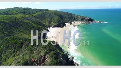 An Aerial View Shows Tourists Enjoying The Waves At Whites Beach In Byron's Bay, Australia - Video Drone Footage