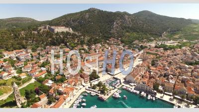 An Aerial View Shows The Port Town Of Hvar, Croatia With Boats Docked In The Harbor - Video Drone Footage