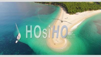 An Aerial View Shows Boats Anchored By Zlatni Rat Beach On Brac Island, Croatia - Video Drone Footage