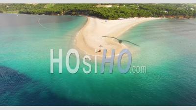 An Aerial View Shows Tourists Enjoying Zlatni Rat Beach On Brac Island, Croatia - Video Drone Footage