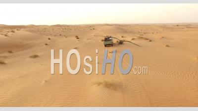 Tourists Drive Through A Desert In Dubai, United Arab Emirates - Video Drone Footage