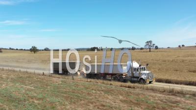 2020 - Twelve Wheeler Towing A Vehicle Behind It In The Countryside Of Parkes, New South Wales, Australia - Video Drone Footage