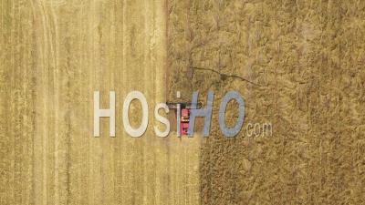 2020 - An Excellent Overhead Shot Of A Farming Combine Cutting Through A Field In Parkes, New South Wales, Australia - Video Drone Footage