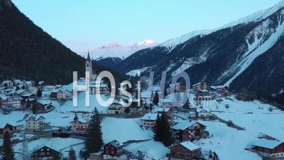 2022 - Excellent Aerial View Of The Wintry Mountain Town Of Schmitten, Switzerland At Sunset - Video Drone Footage